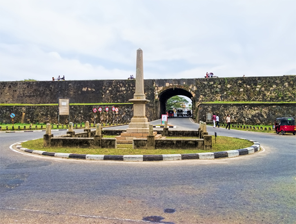 Main Gate to the Galle Fort, with a roundabout and central obelisk monument in front of the arched entrance.